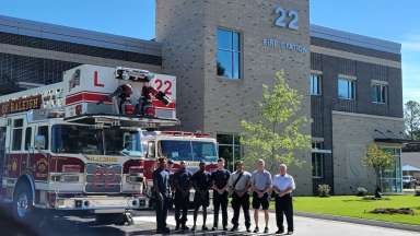 Firefighters stand in front of Station 22