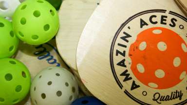 Wooden pickleball paddle and balls