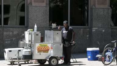 pushcart vendor giving a thumbs up in downtown Raleigh