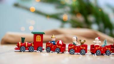 toy train with holiday passengers and a holiday tree