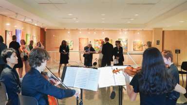A string quartet plays for an artist reception at Block Gallery
