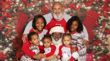 a family taking a picture with santa
