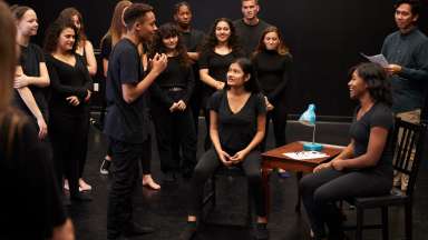 a group of teens acting out a scene