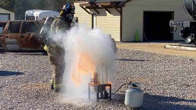 firefighter battles burning deep fryer
