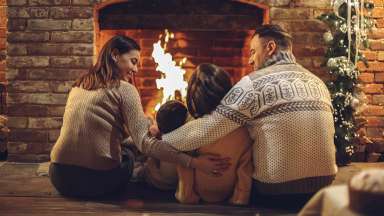 family in front of a fire place
