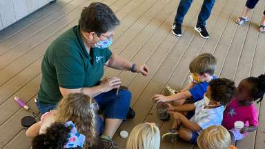 woman teaching kids about nature