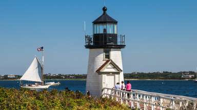 image of a Cape Cod lighthouse and sailboat