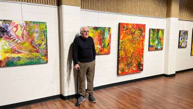 Artist Eduardo Lapetina stands with his artwork at Sertoma Arts Center