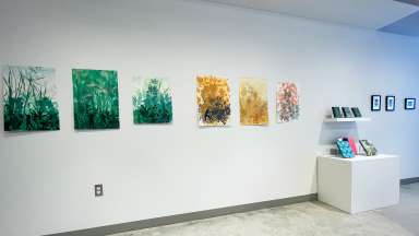 Prints hang in the gallery at Pullen Arts Center