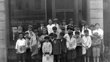 historic image of young boys in front of business