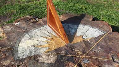 A sundial created on a stump