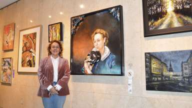 Tracie Fracasso stands next to her artwork Moretta Imago