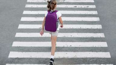 Child walking in crosswalk