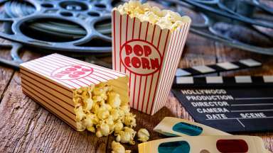 image of popcorn in box, movie reels and 3D glasses
