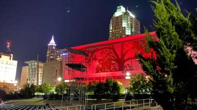 performing arts center lit up in red