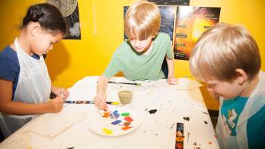 children painting at a table