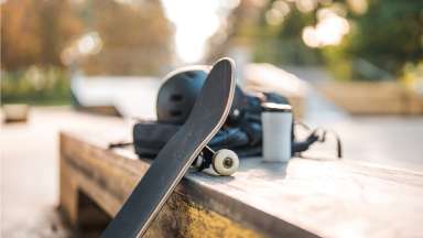 skate board leaned against a bench