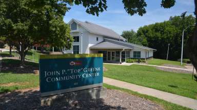 The exterior of John P Top Greene community center and its sign