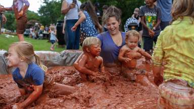 a family playing in the mud