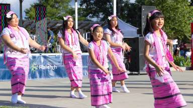 girls in pink cultural outfits dancing