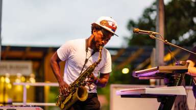 man playing a saxophone on stage