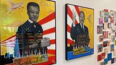 Portraits of John Chavis and Martin Luther King, Jr. are hung on a wall next to smaller square artworks