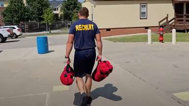 Fire recruit carry two bags as part of agility test
