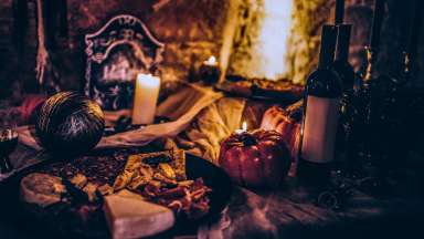 candlelit Halloween themed table with charcuterie
