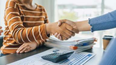 Shaking hands, Close up group of business woman discussion and brainstorming, bookkeeping audit graph and chart documents at desk, teamwork concept.
