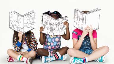 an image of children reading a book sitting crisscross applause style