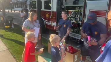 Children gather near the fire truck and Raleigh firefighters at the festival