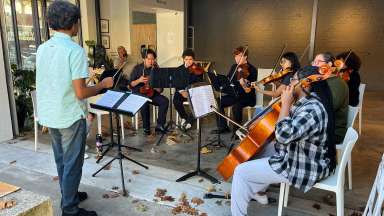 a group of people playing string instruments