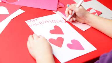 child making a valentine's day card