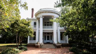 the exterior of a white historic house