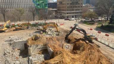 Civic Tower job site showing the basement and crews working to dig it out.