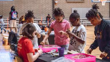 people at an event doing crafts