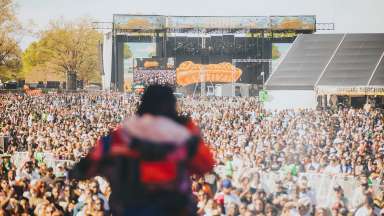 View of Dreamville crowd from stage with back of singer in view