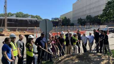 The design team and construction team gathered at dirt for groundbreaking