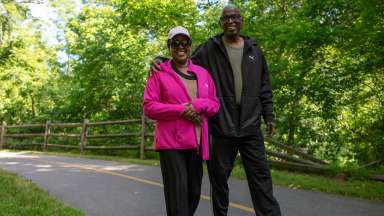 a couple walking and smiling on the greenway trail