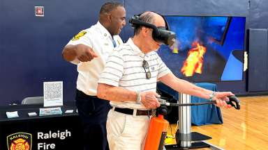 Man is using virtual reality fire extinguish to learn how to use one