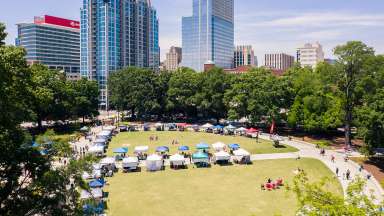 an aerial image of moore square with vendor tents