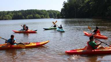 a group of teens enjoying kayaking