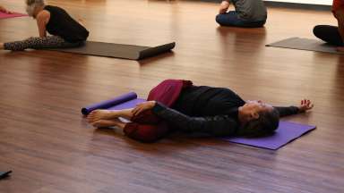 People doing yoga in an art gallery.