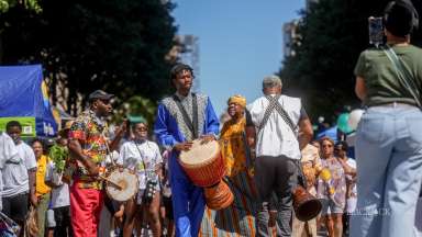 The African American Cultural Festival street scene with African drummers and an enthusiastic crowd.