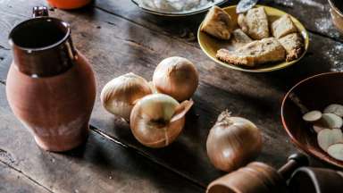 an image of historic tabletop with onions