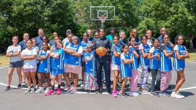 Chief Patterson standing on court with girls basketball team