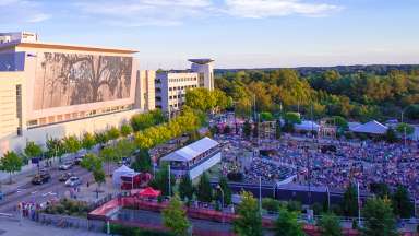 Aerial view of the Red Hat Amphitheater next to the Raleigh Convention Center's shimmering wall