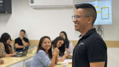 an image of person speaking in front a class