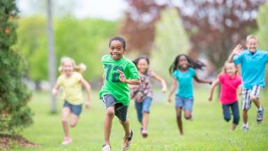 an image of children running in a field