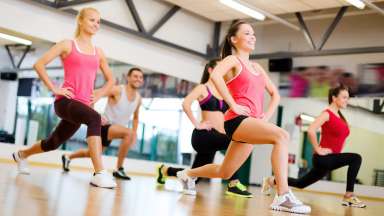 a group of people doing a fitness class in a studio